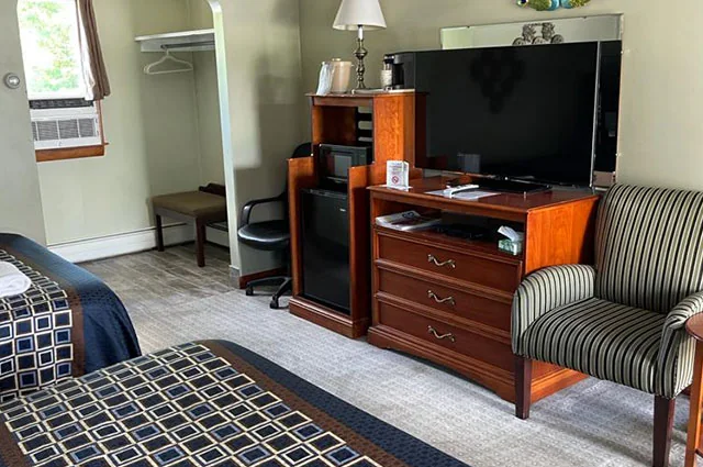 Spacious Colonial Motel guest room with two beds